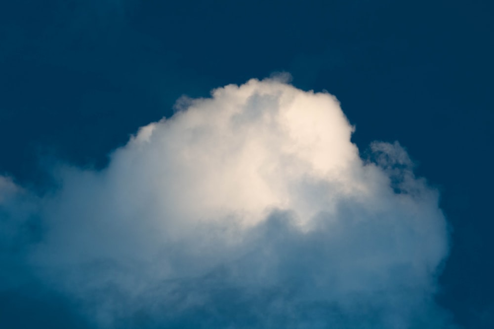 a large white cloud in a blue sky