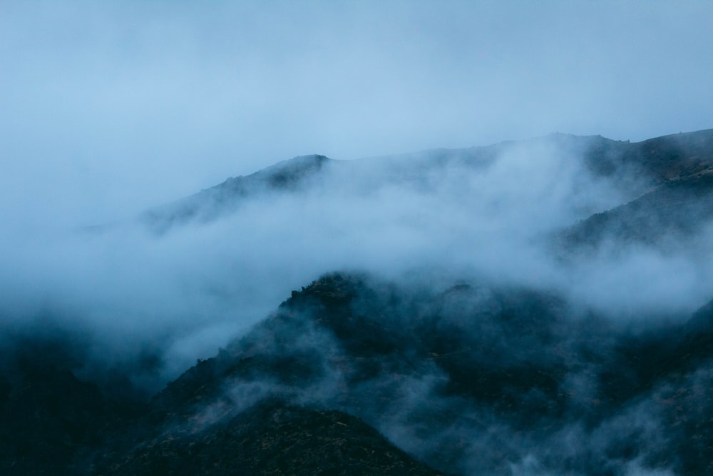 a view of a mountain covered in clouds