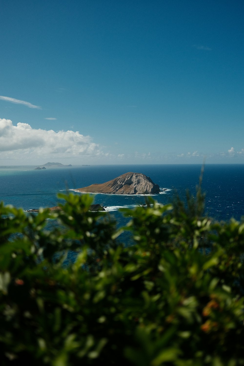 a view of a small island in the middle of the ocean