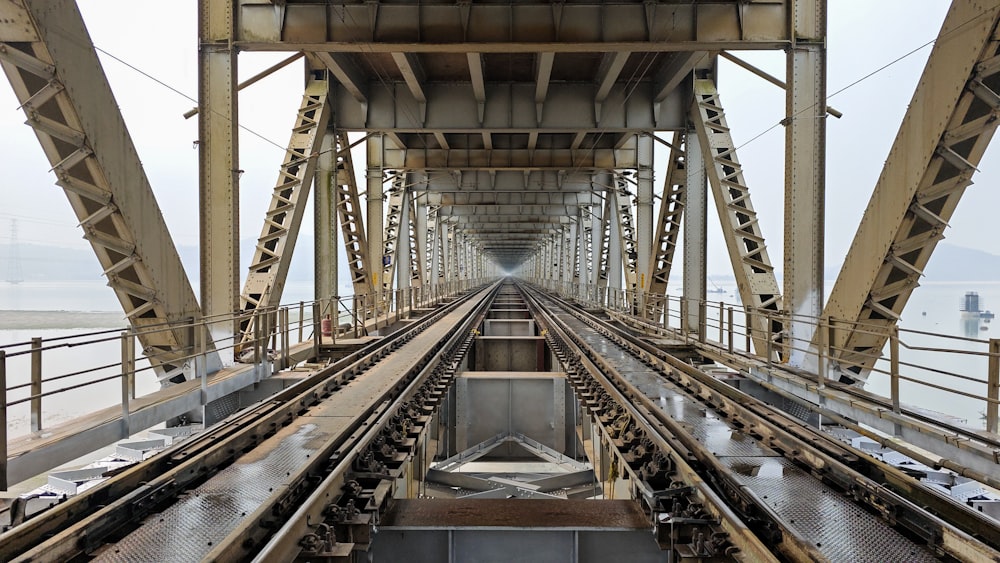a view of a train track from the top of a bridge