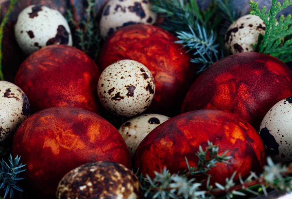 a basket filled with lots of red and white eggs