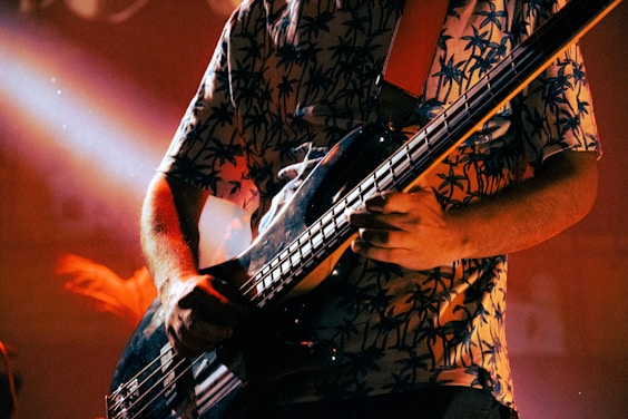 a man playing a bass guitar on stage