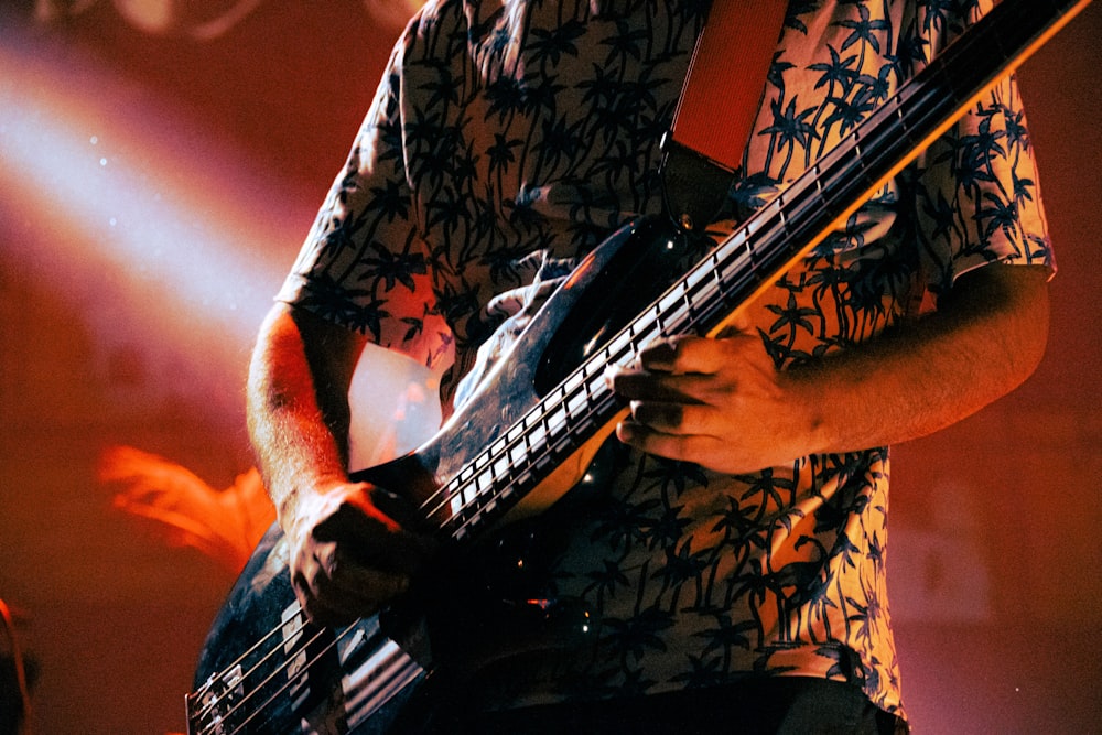 a man playing a bass guitar on stage