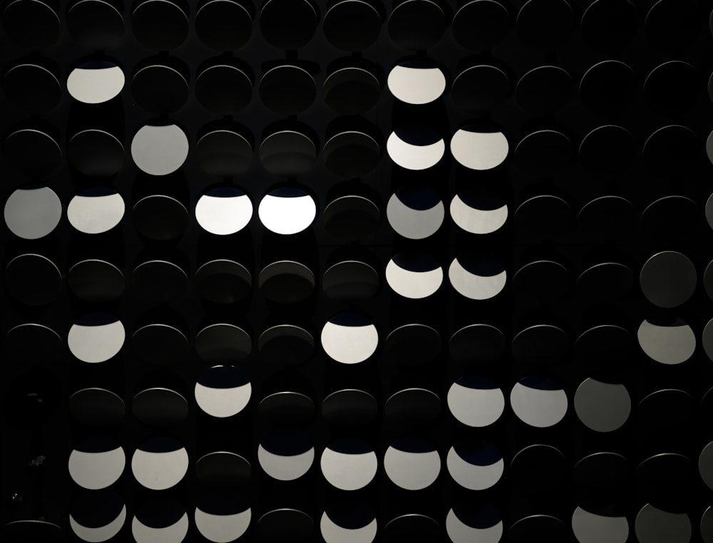 a black and white photo of circles on a wall