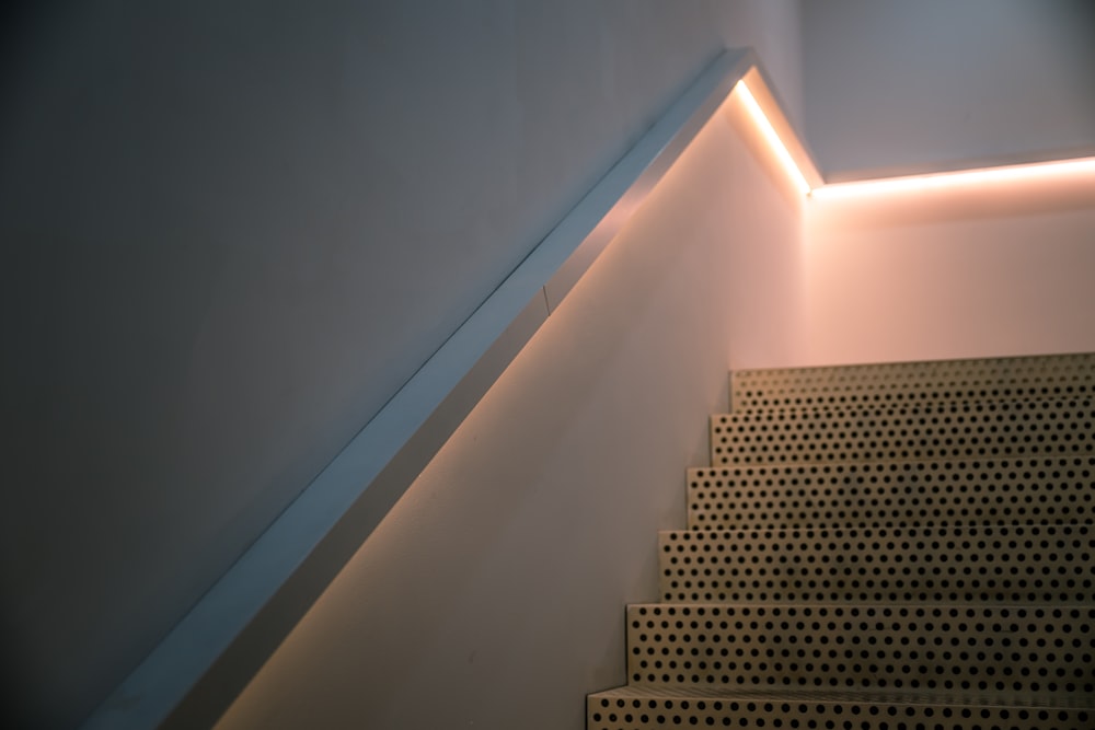 a stair case with a light on the side of it