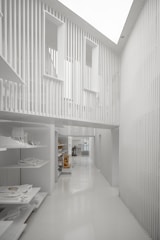 a long white hallway with a skylight above it