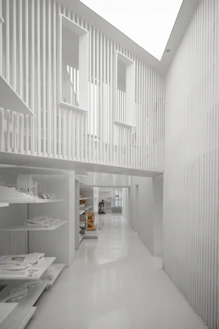 a long white hallway with a skylight above it