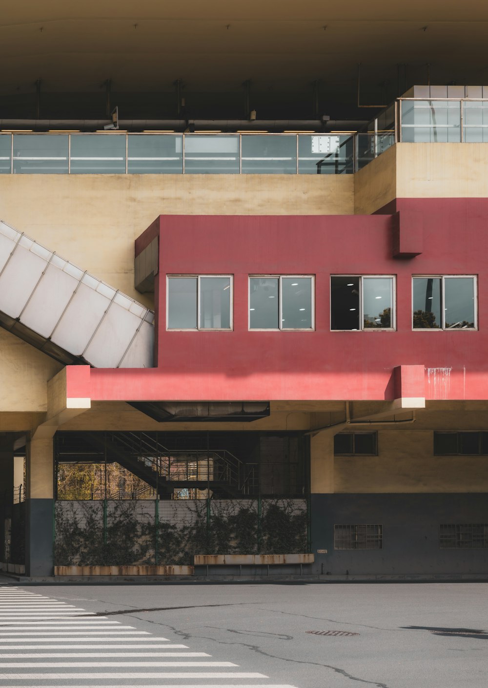 a red building with a red roof and windows