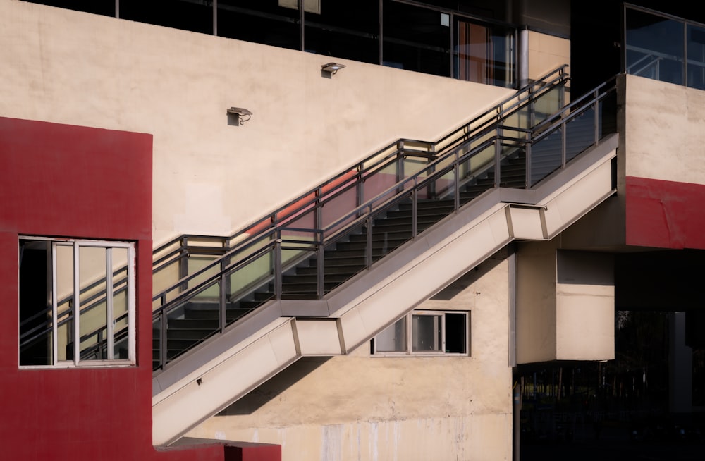a red and white building with a stair case