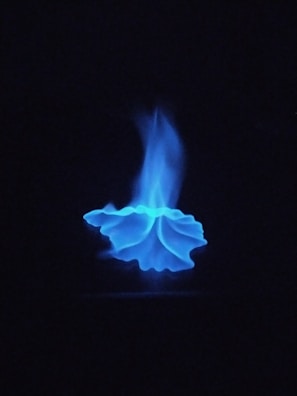 a blue flame is seen in the dark