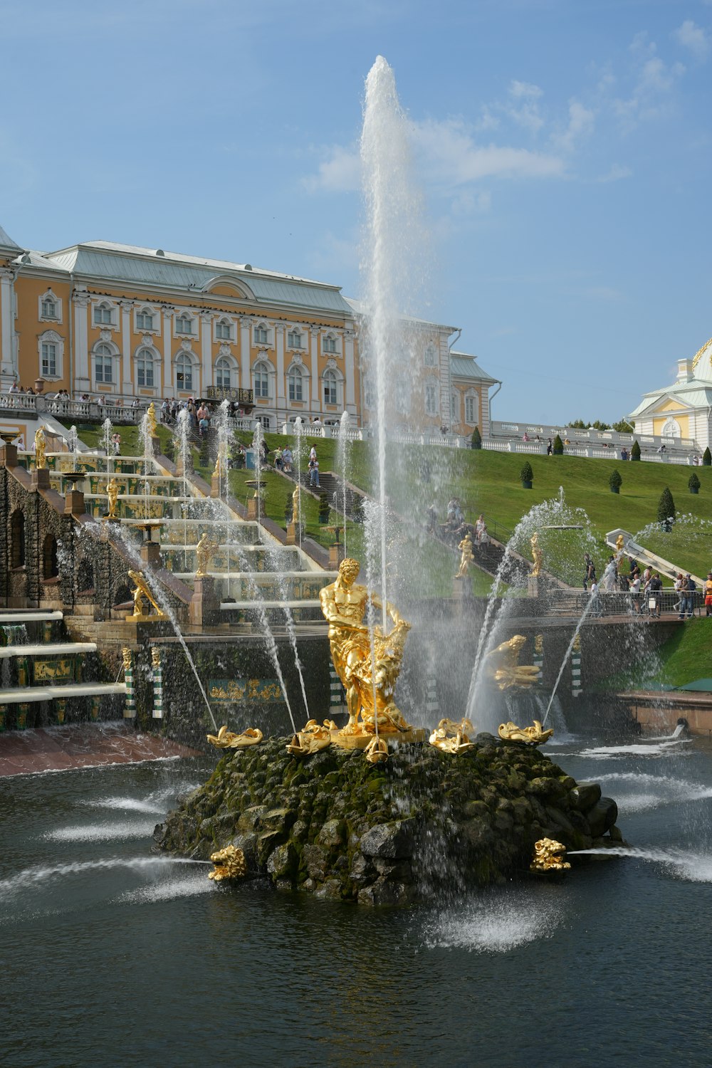 a water fountain in front of a large building