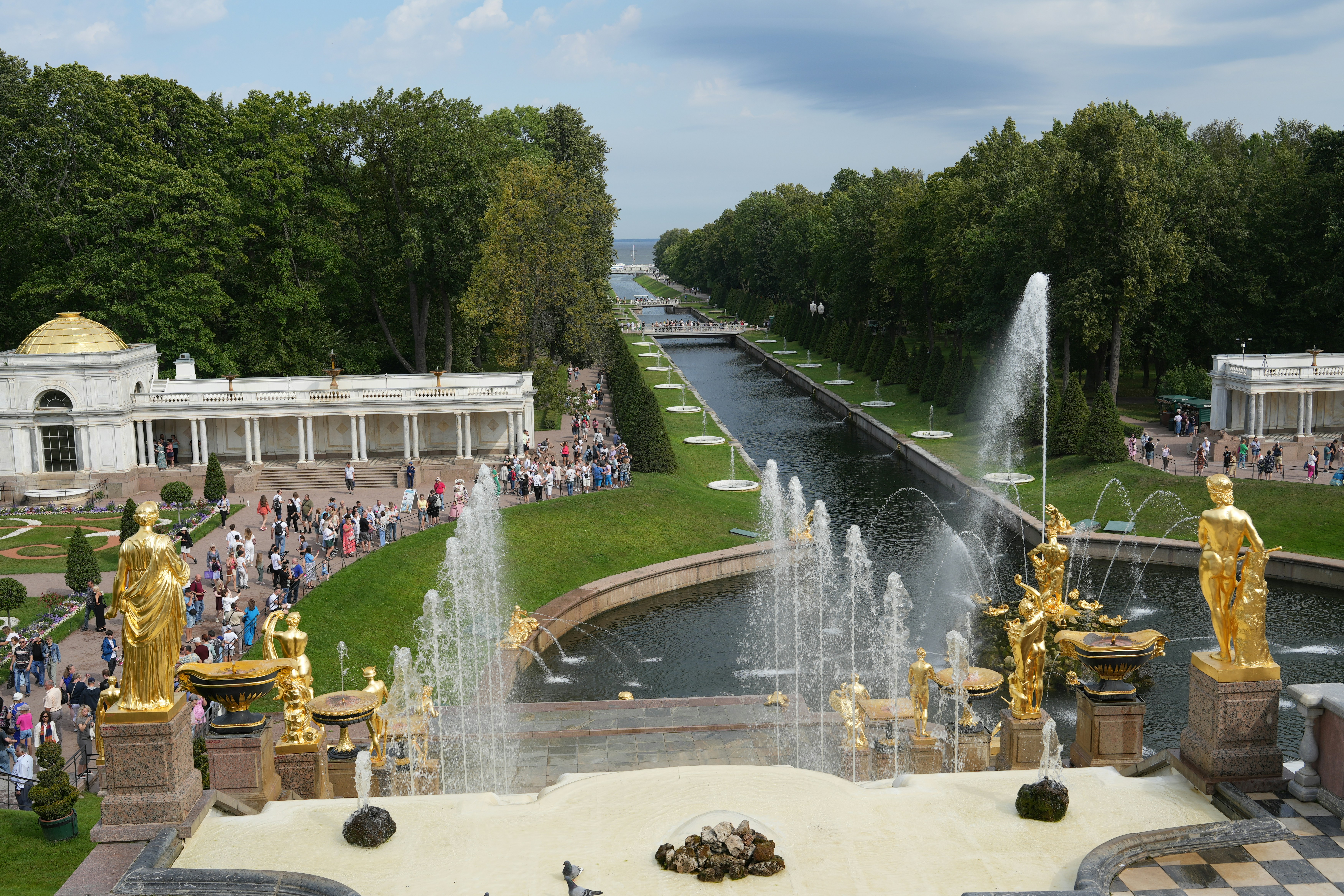 a view of a park with fountains and people
