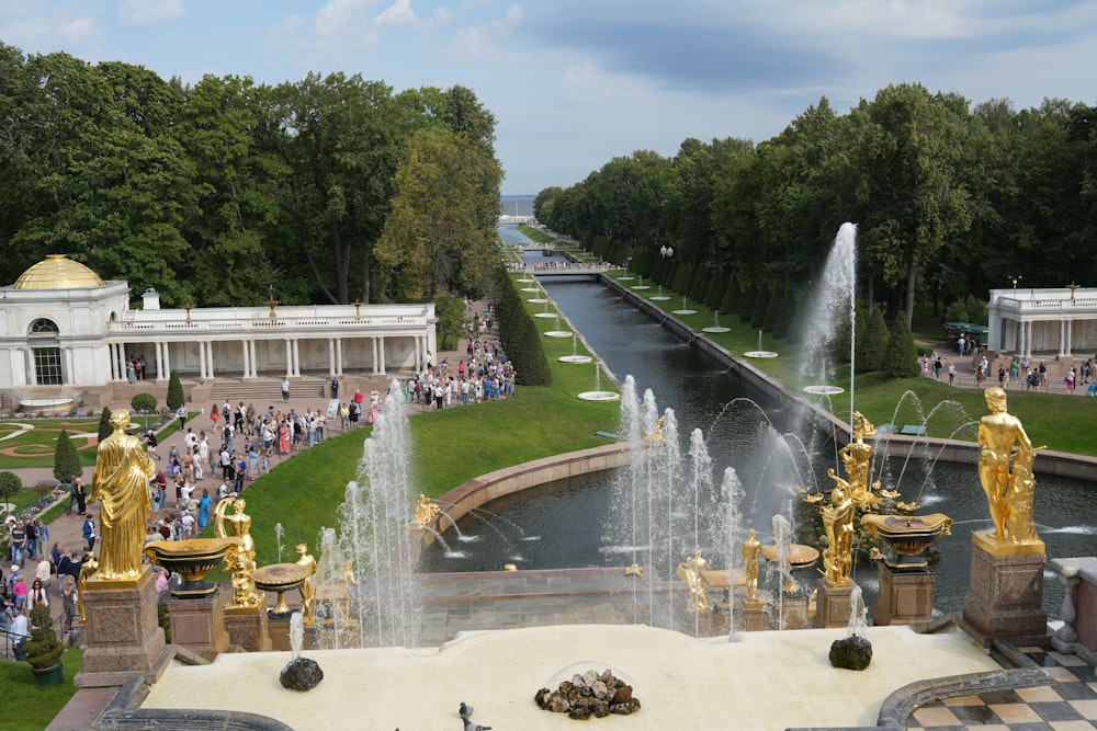 a view of a park with fountains and people