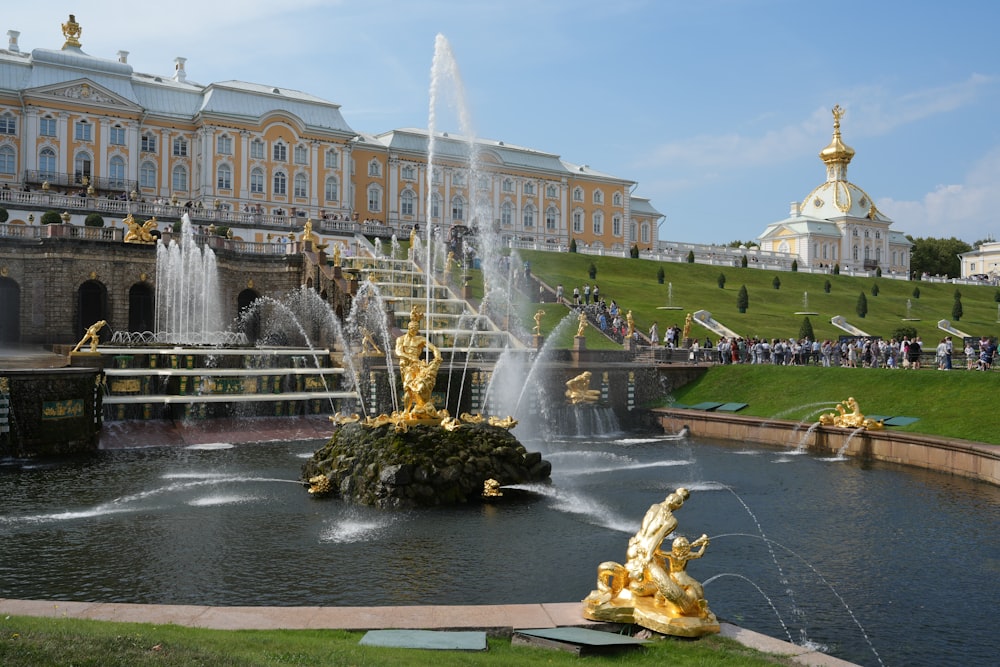 a water fountain in front of a large building