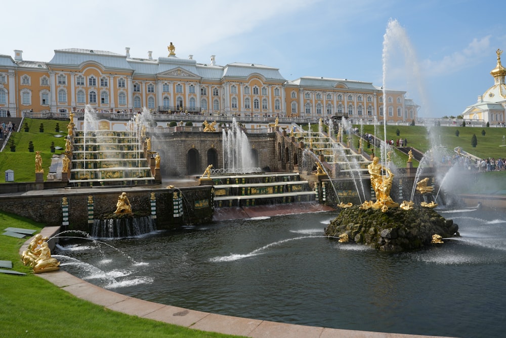 a water fountain in front of a large building