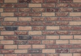 a brick wall with a clock on the side of it