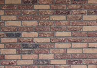a brick wall with a clock on the side of it