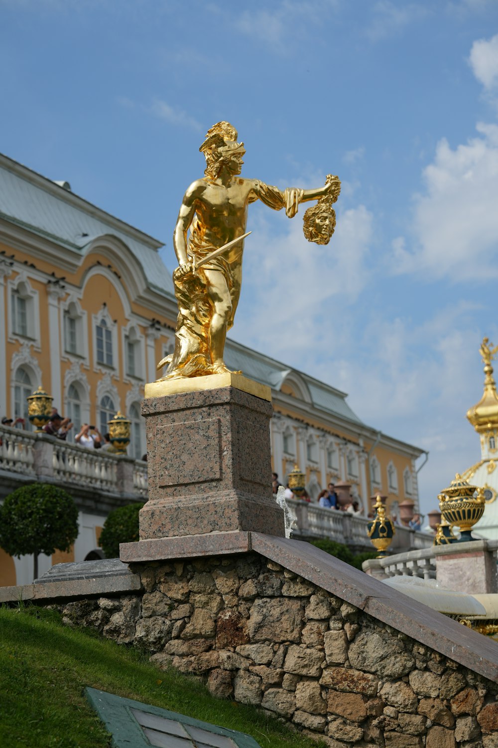 a statue of a man holding a scale in front of a building