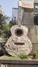 a guitar is on display in front of a building