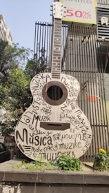 a guitar is on display in front of a building