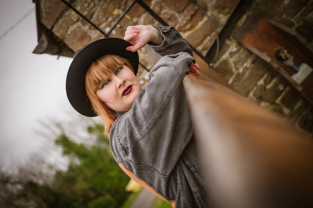 a young girl wearing a black cowboy hat