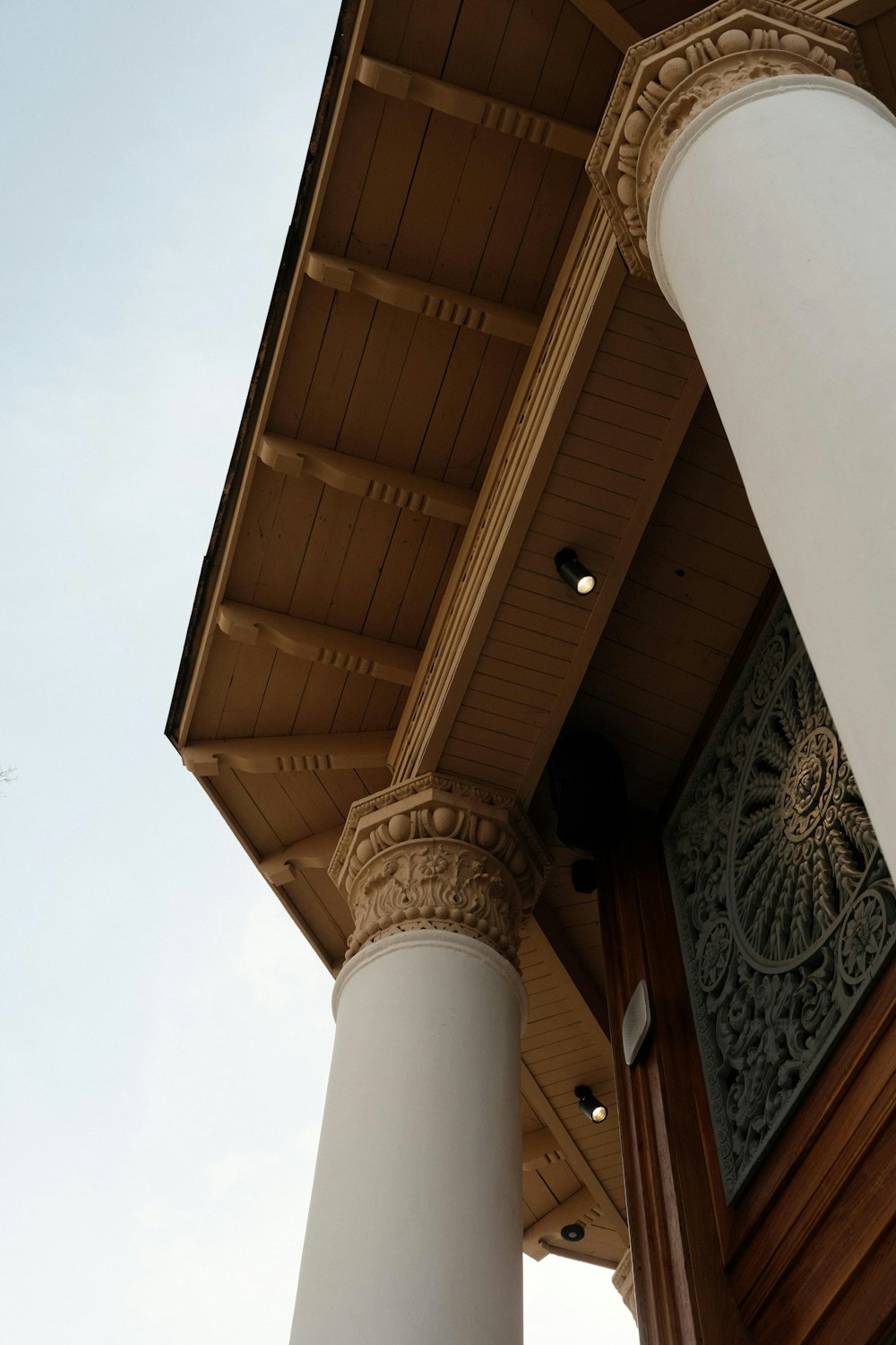 a close up of a building with columns and a clock