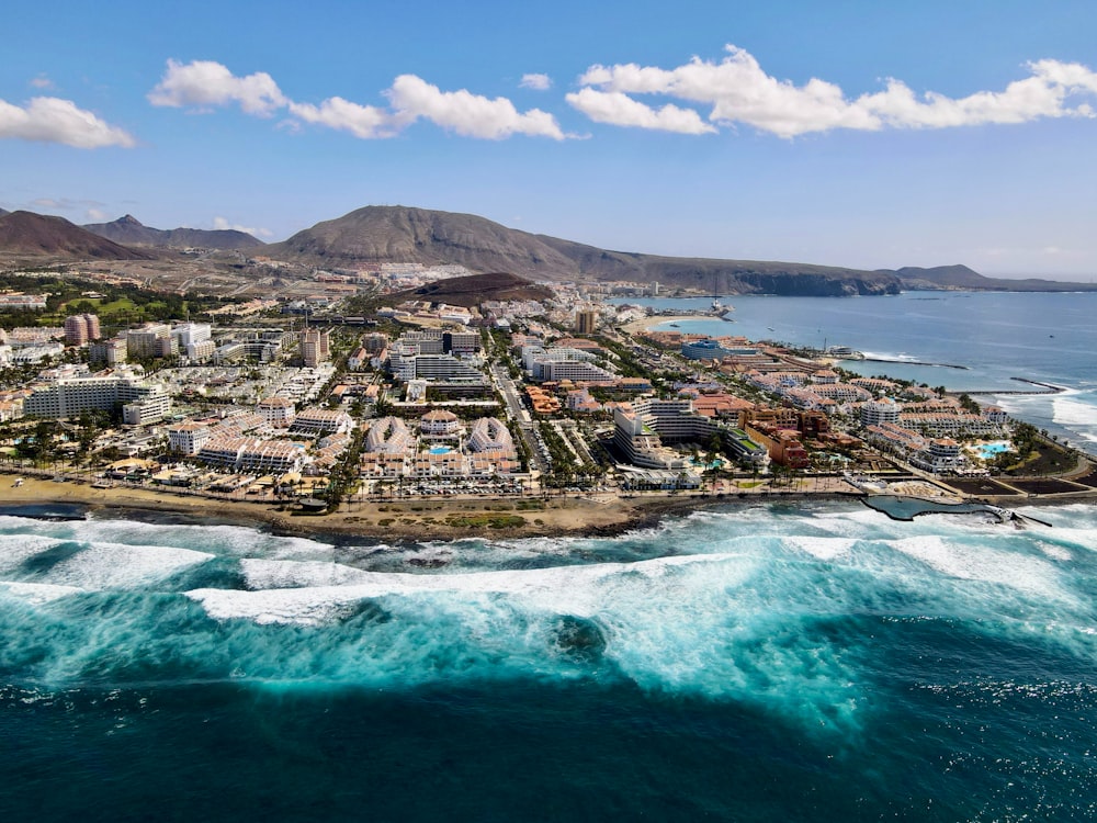 an aerial view of a city by the ocean