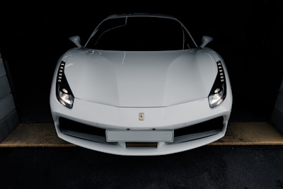 a white sports car parked in a garage