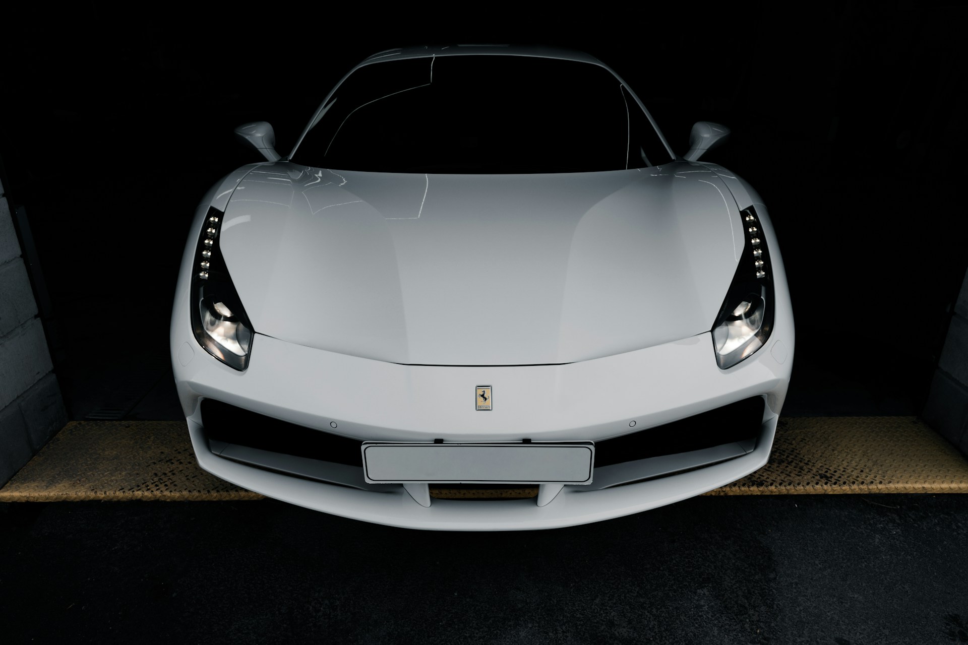 a white sports car parked in a garage
