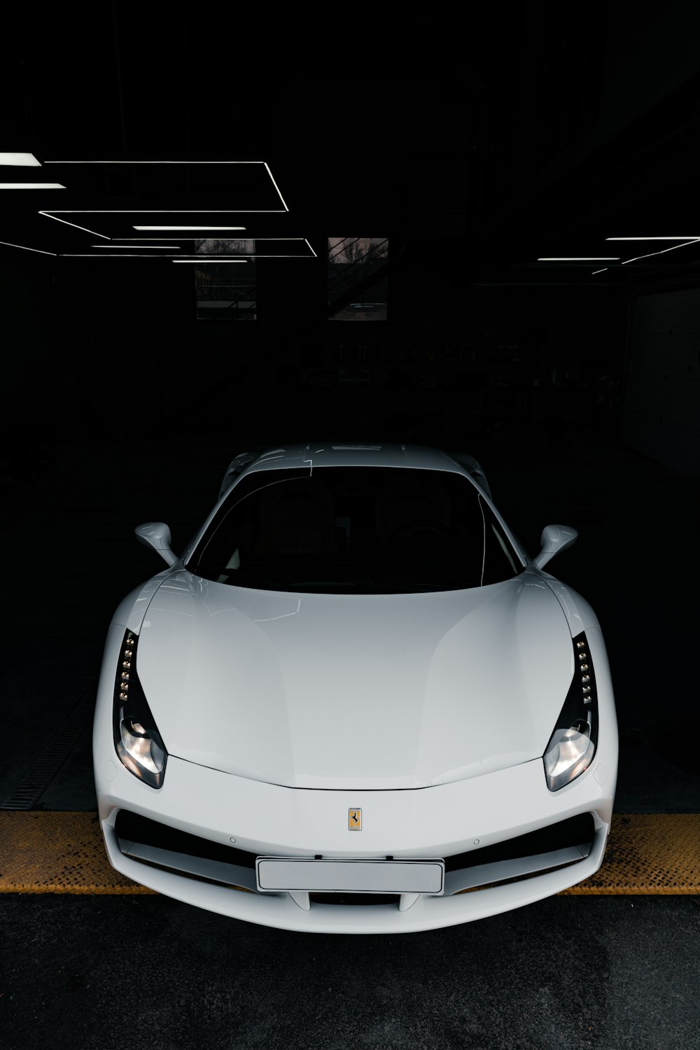 a white sports car parked in a garage