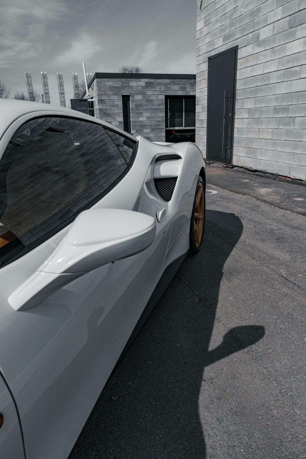 a white sports car parked in front of a building