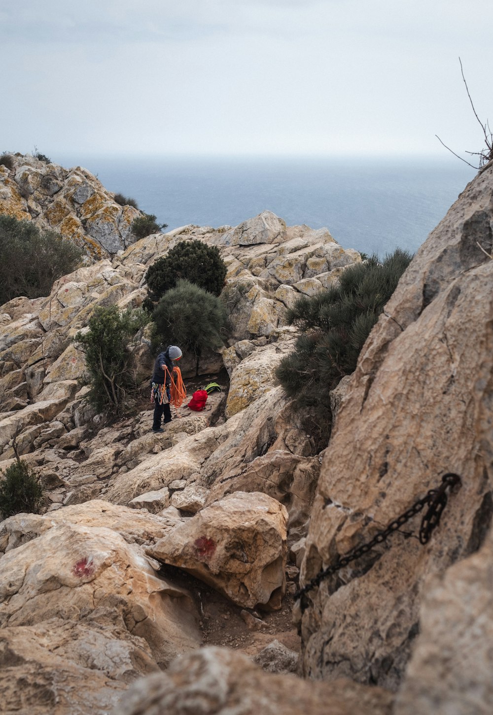 a couple of people standing on top of a rocky hillside