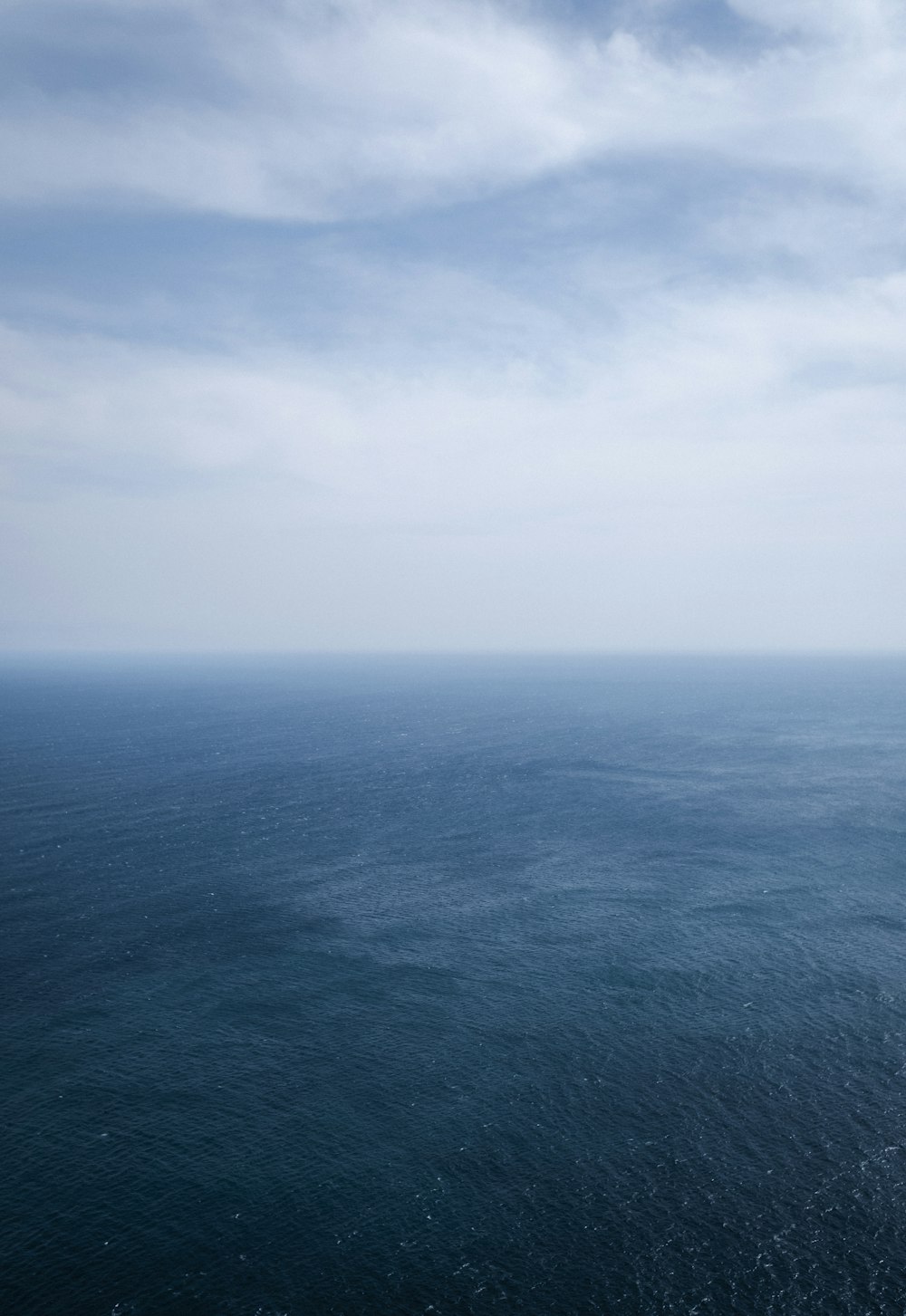 a large body of water sitting under a cloudy sky