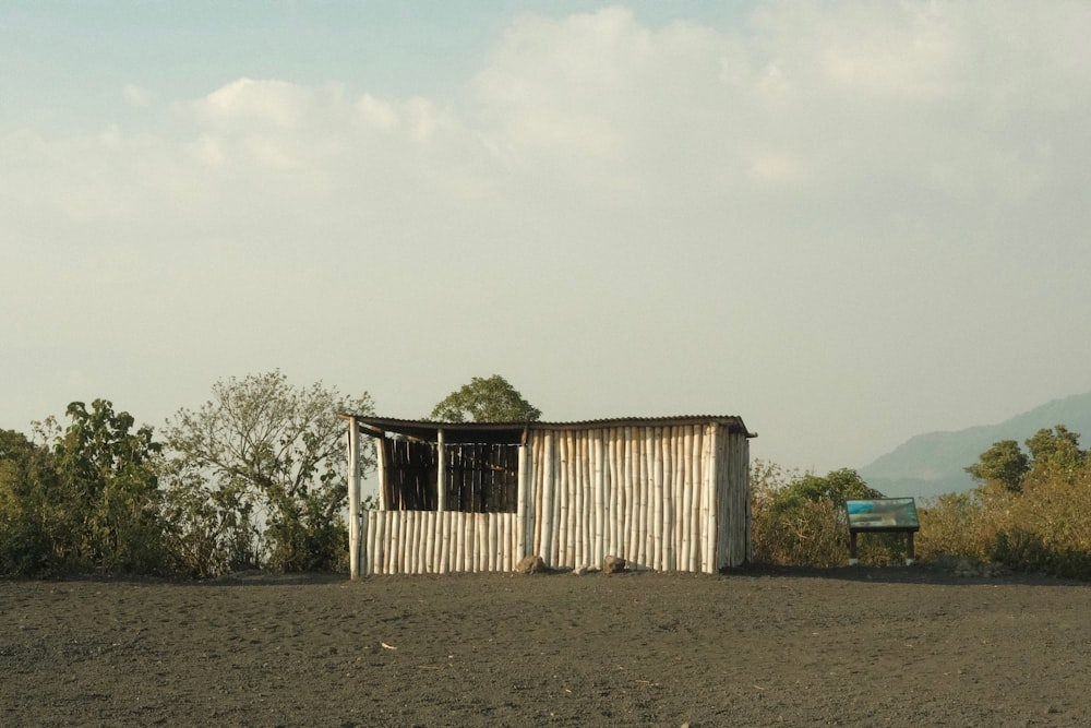 a small shack sitting in the middle of a field