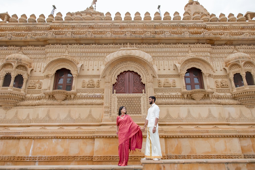 a man and a woman standing on the steps of a building