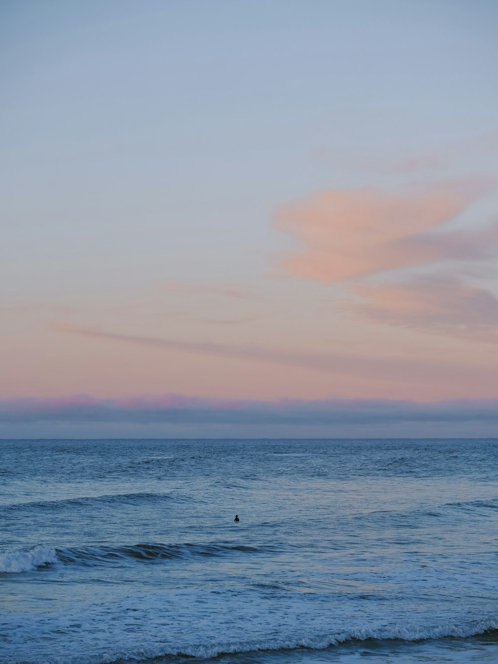 a person riding a surfboard on a wave in the ocean