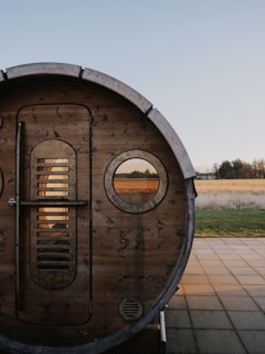 a wooden barrel sitting on top of a sidewalk
