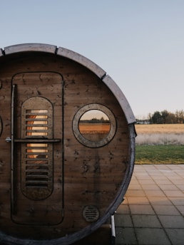 a wooden barrel sitting on top of a sidewalk