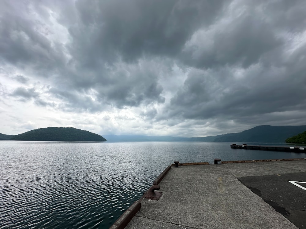 a body of water under a cloudy sky