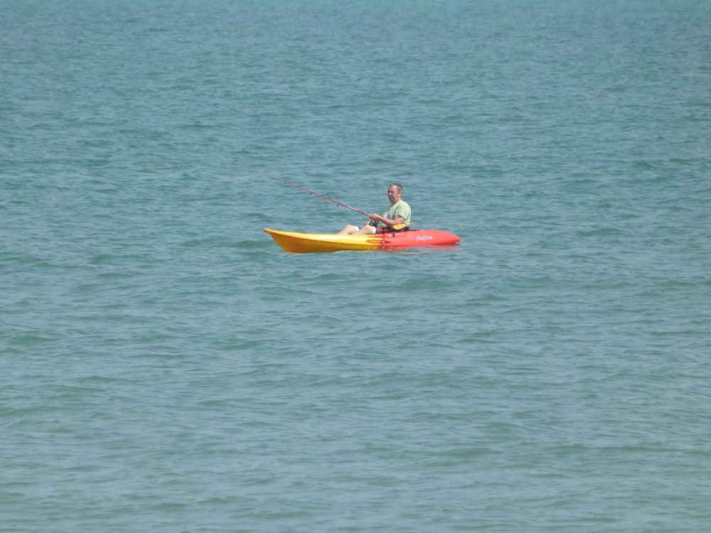 a man on a kayak in the middle of the ocean