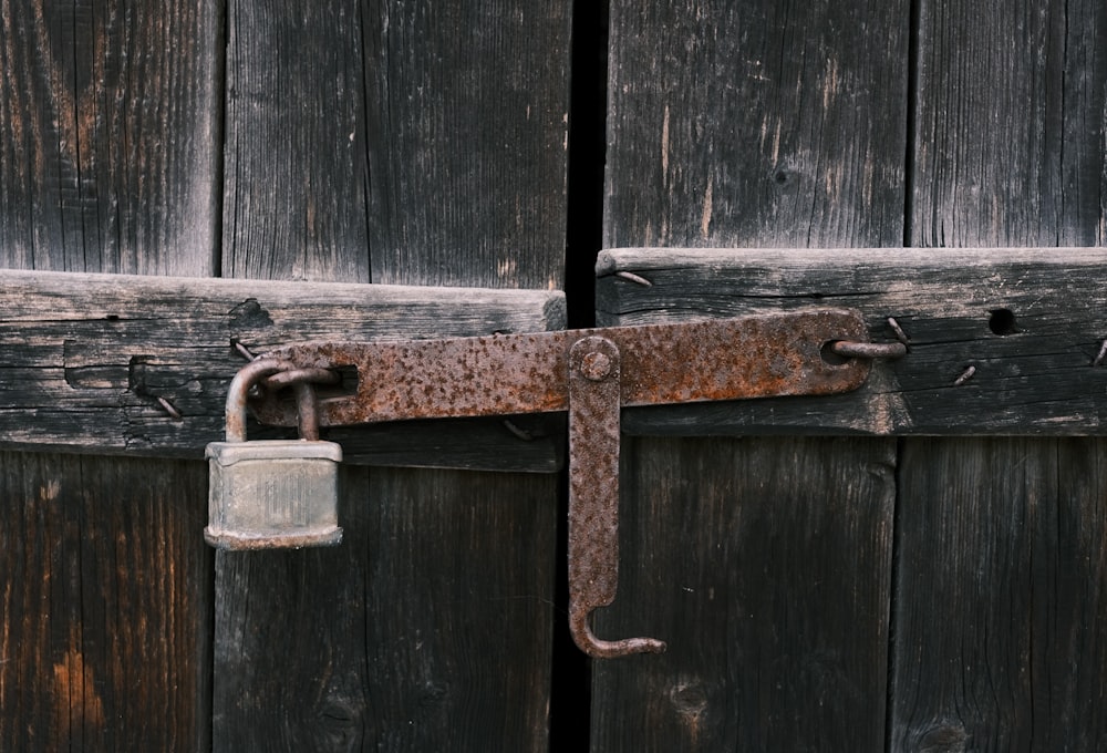 a lock on a wooden door with a padlock