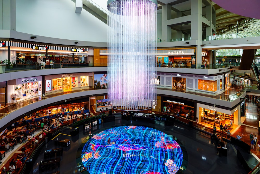 a large chandelier hanging from the ceiling of a shopping mall