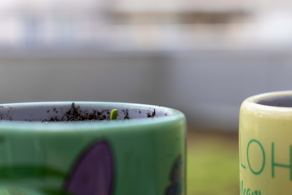 a close up of two coffee cups on a table