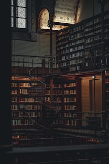 a large library with a spiral staircase and lots of books