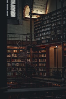 a large library with a spiral staircase and lots of books