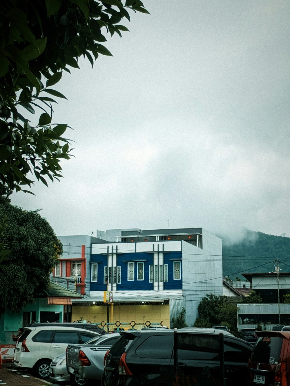 a parking lot with cars parked in front of a building