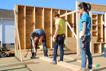 a couple of women standing on top of a wooden floor