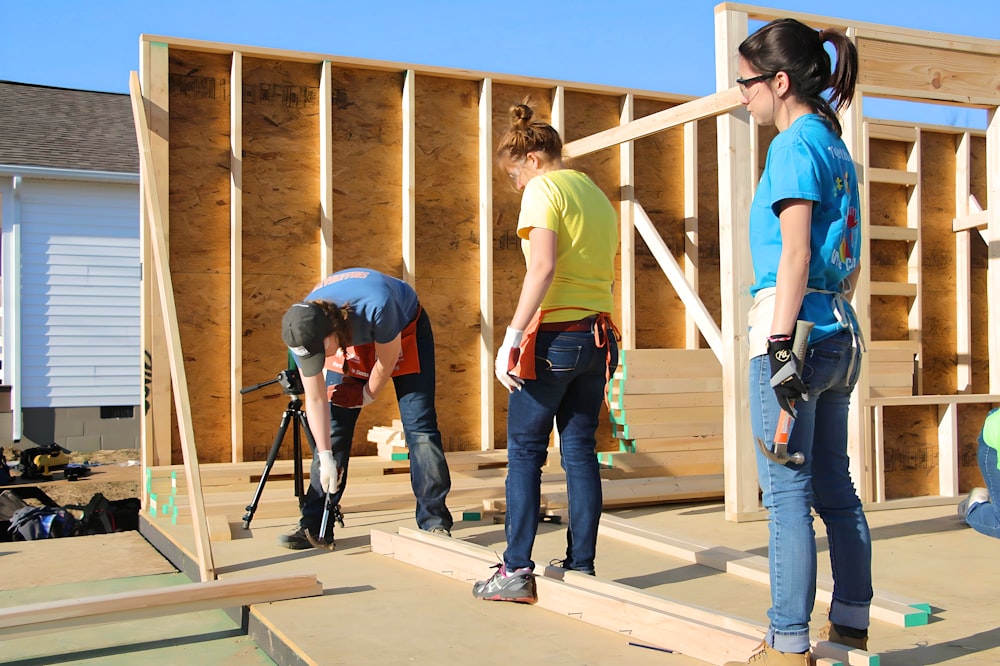 a couple of women standing on top of a wooden floor