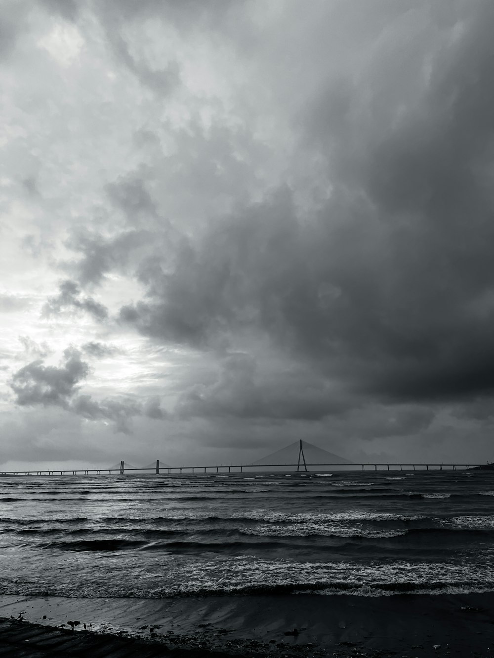 a large body of water under a cloudy sky