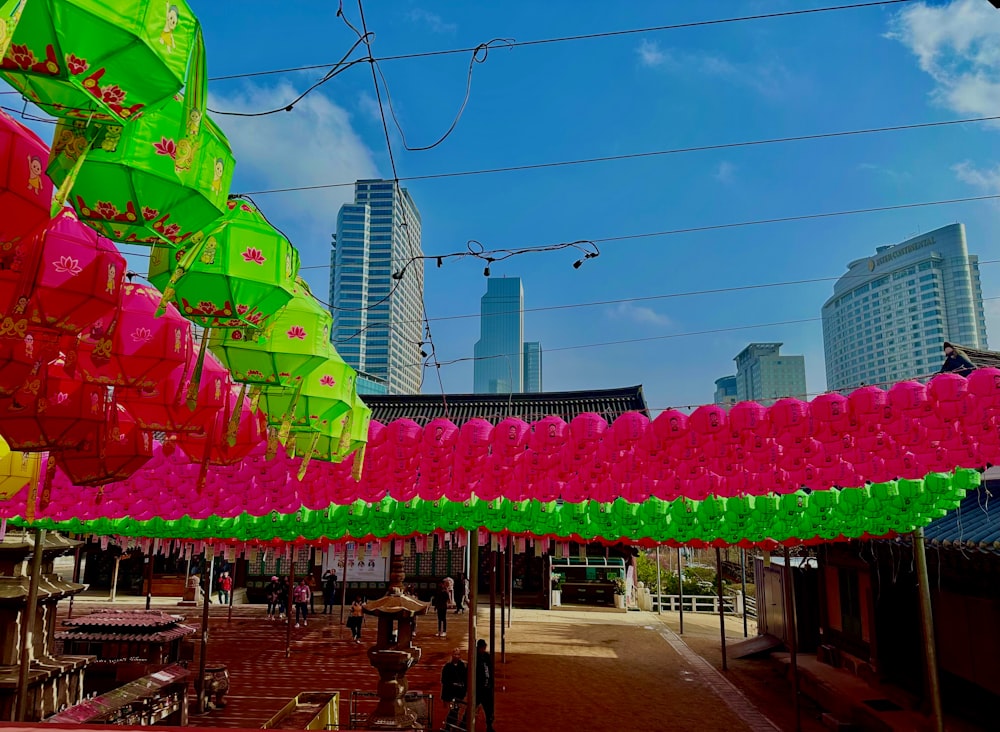 a bunch of colorful umbrellas hanging in the air